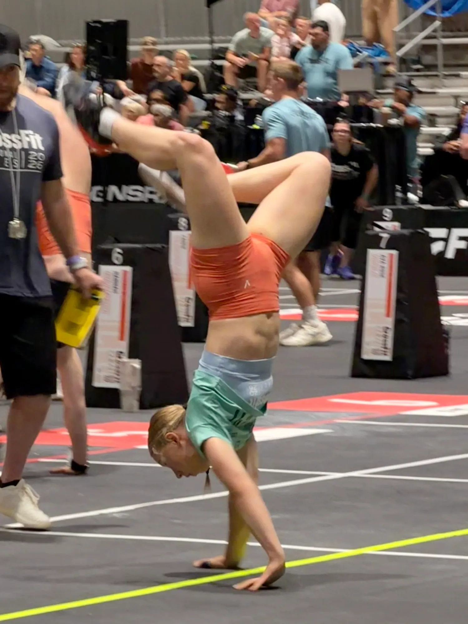 Lucy mid handstand walk on the Games floor, San Jose 2026